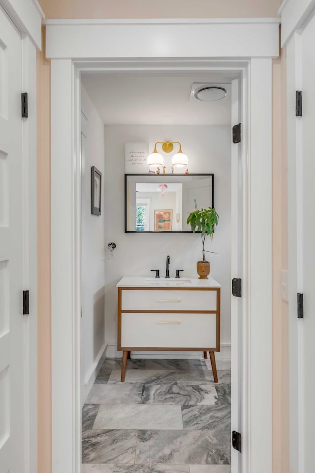 bathroom featuring marble finish floor and vanity