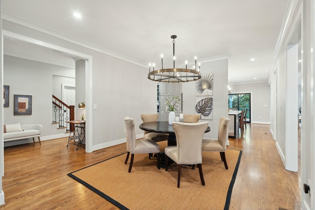 dining room with stairs, light wood finished floors, baseboards, and crown molding