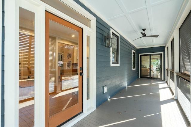 unfurnished sunroom with a ceiling fan