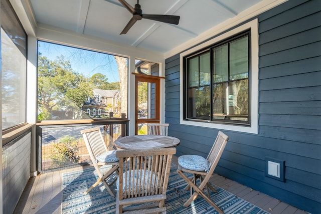 sunroom / solarium featuring a ceiling fan and a healthy amount of sunlight