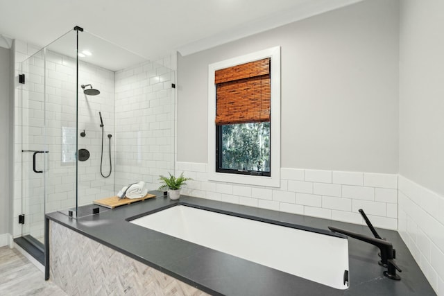 full bath featuring a garden tub and a shower stall