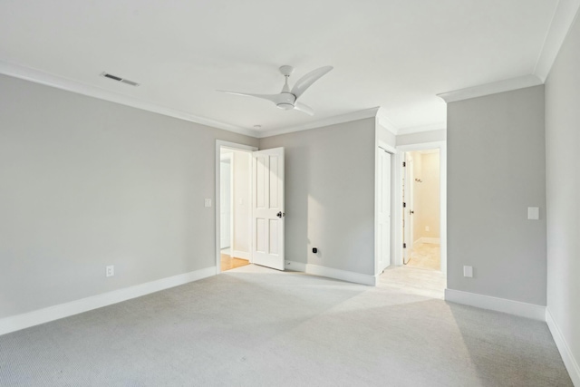 spare room with light carpet, visible vents, and baseboards