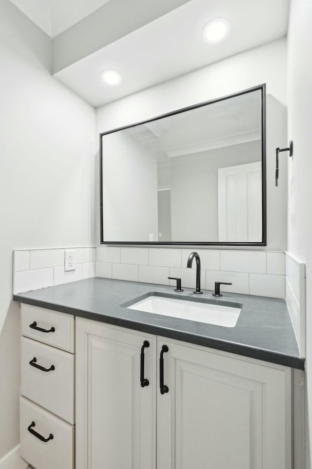 bathroom with recessed lighting, vanity, and decorative backsplash