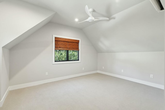 additional living space featuring carpet, baseboards, vaulted ceiling, and a ceiling fan