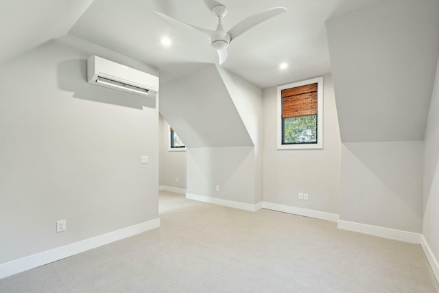 additional living space featuring light carpet, lofted ceiling, baseboards, and a wall mounted air conditioner