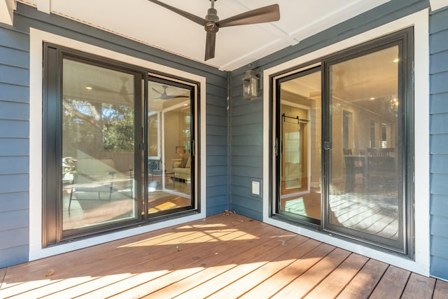 wooden deck featuring a ceiling fan