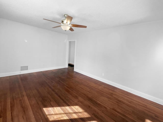 spare room with ceiling fan and dark hardwood / wood-style floors