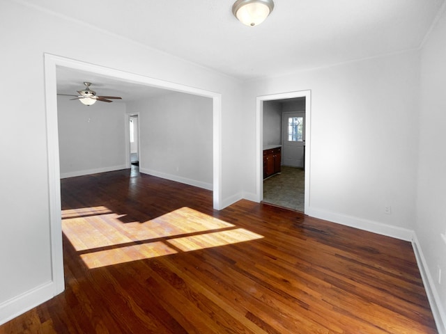 spare room featuring ceiling fan and dark hardwood / wood-style flooring