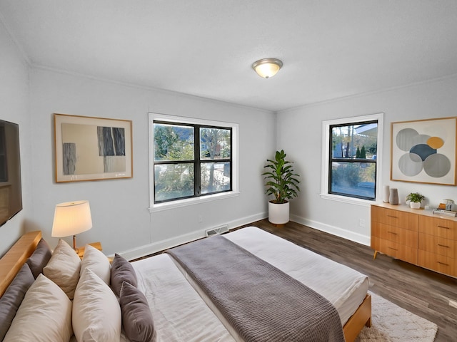 bedroom featuring dark hardwood / wood-style flooring and crown molding