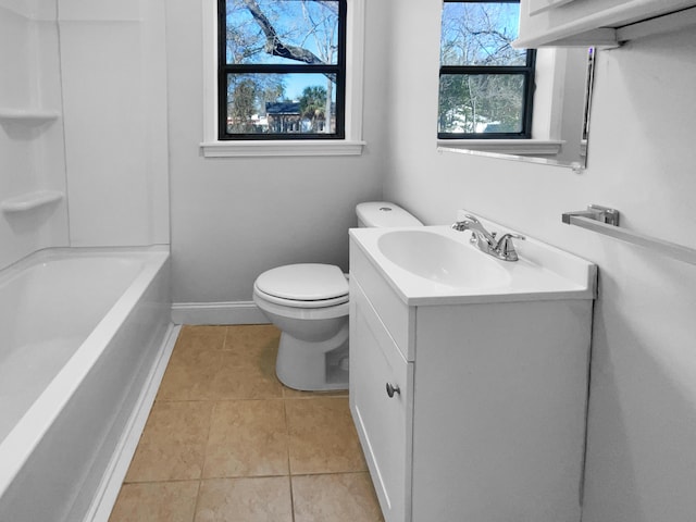 full bathroom featuring toilet, vanity, tile patterned floors, and shower / bath combination