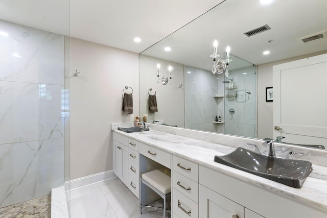bathroom with a marble finish shower, visible vents, marble finish floor, and a sink