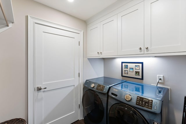 laundry room with cabinet space and washer and clothes dryer