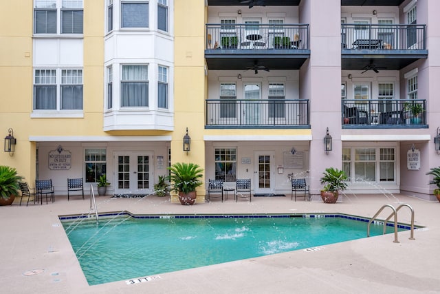 pool featuring ceiling fan, a patio area, and french doors