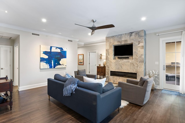 living area with baseboards, a ceiling fan, visible vents, and dark wood finished floors