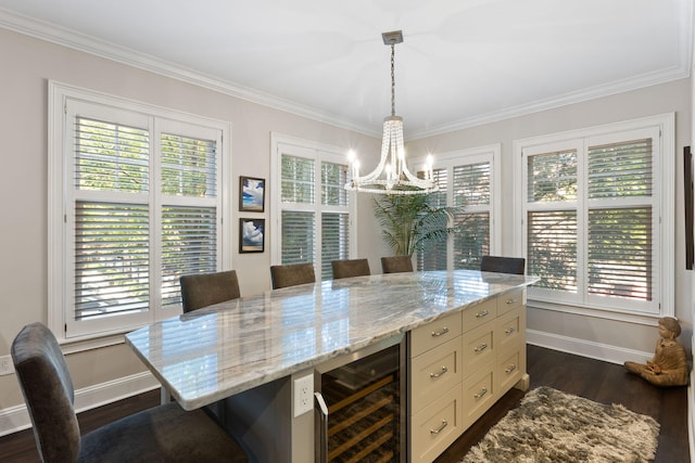 dining area featuring wine cooler, crown molding, an inviting chandelier, plenty of natural light, and baseboards