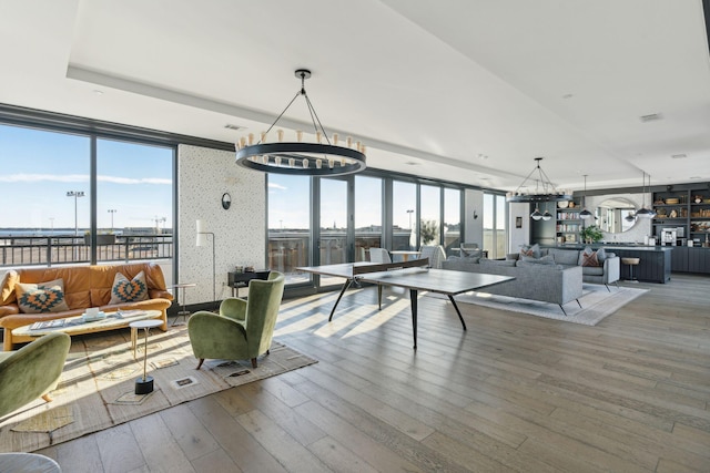 living room featuring an inviting chandelier and wood-type flooring