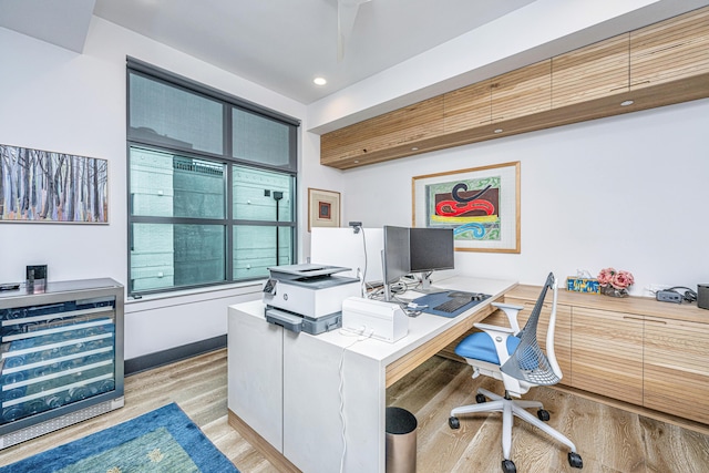 office area featuring beverage cooler and light wood-type flooring