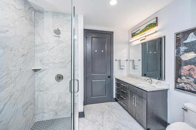 bathroom with vanity, an enclosed shower, and toilet