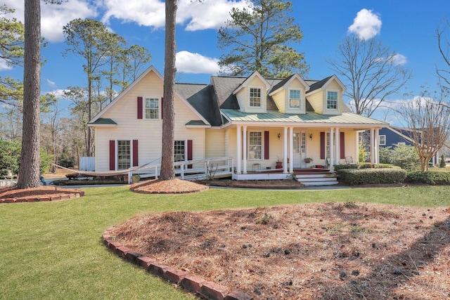 view of front of property featuring covered porch, metal roof, a standing seam roof, and a front yard