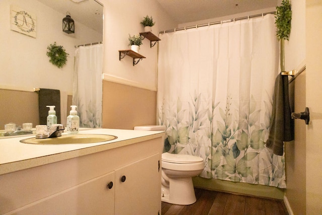 bathroom with hardwood / wood-style flooring, vanity, and toilet