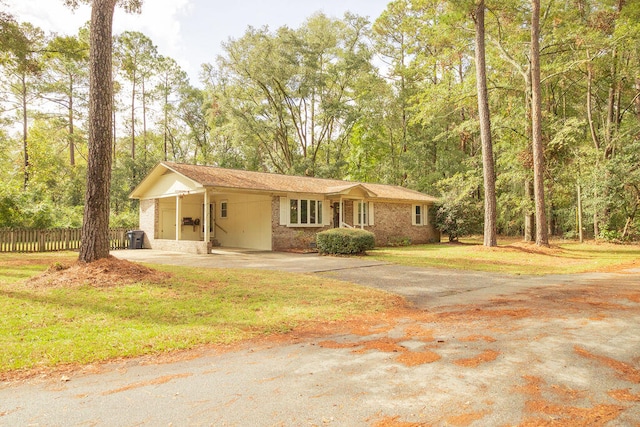 single story home featuring a front lawn and a carport