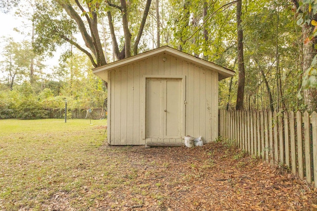 view of outbuilding featuring a lawn