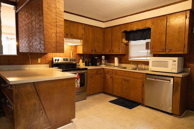 kitchen with decorative backsplash, stainless steel appliances, a textured ceiling, and sink