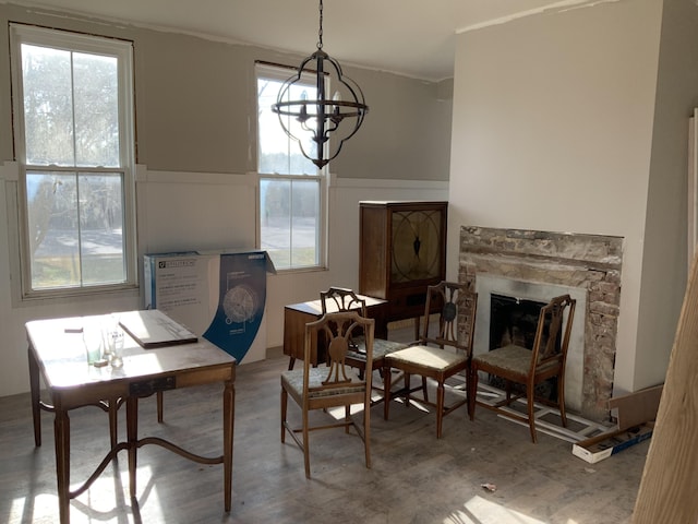 sitting room featuring a notable chandelier, a fireplace, and wood-type flooring