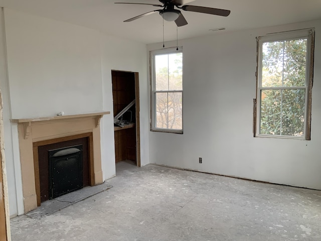 unfurnished living room featuring ceiling fan