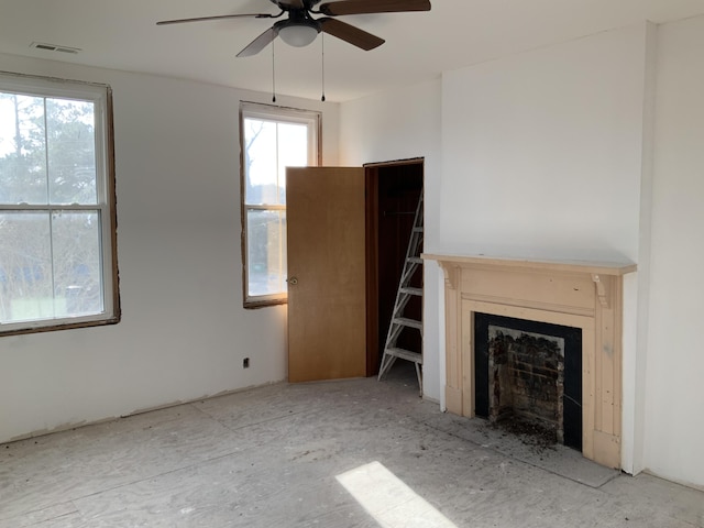 unfurnished living room featuring ceiling fan