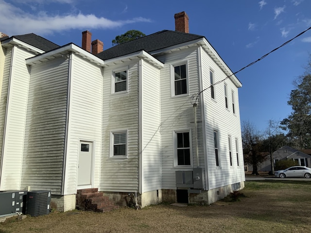 rear view of property featuring central air condition unit