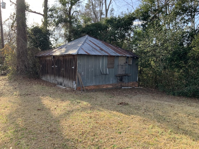 view of outbuilding with a lawn