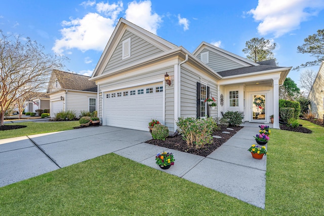 view of front of house with a garage, a front lawn, and driveway