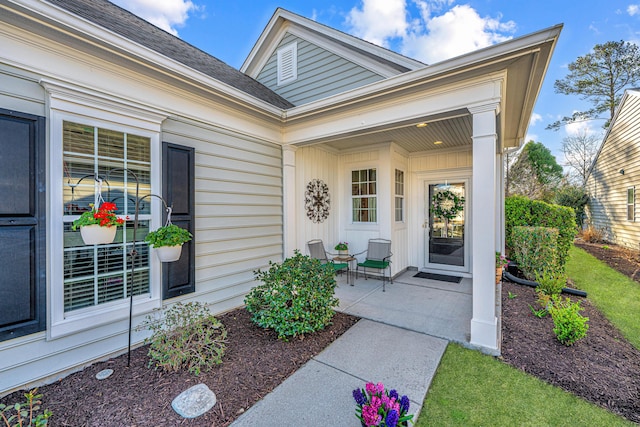 property entrance with a shingled roof