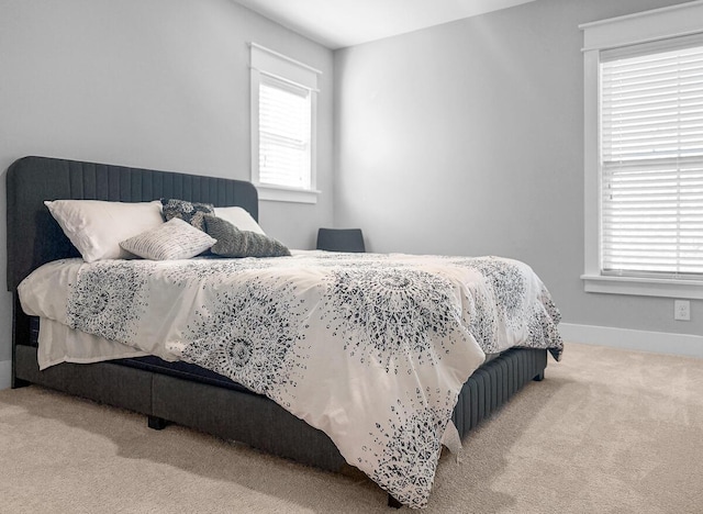 carpeted bedroom featuring baseboards