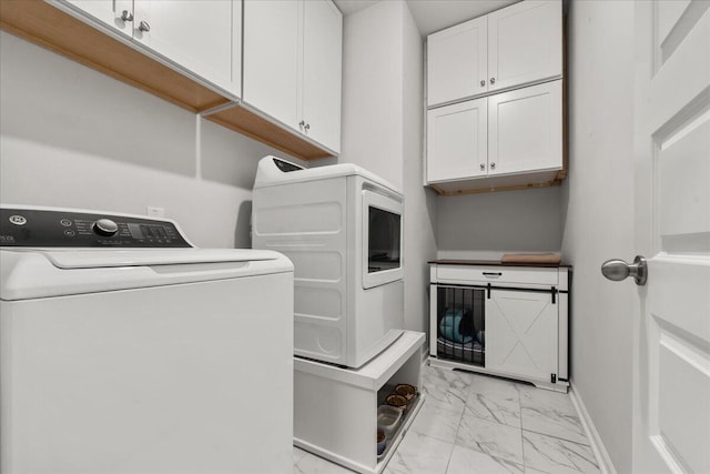 laundry room with cabinets and washing machine and dryer