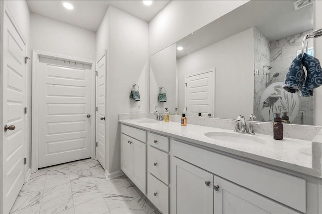 bathroom with walk in shower and vanity