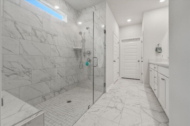 bathroom featuring walk in shower and vanity