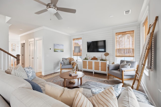 living room featuring light hardwood / wood-style floors, ceiling fan, and crown molding