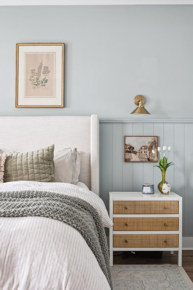 bedroom with dark hardwood / wood-style floors