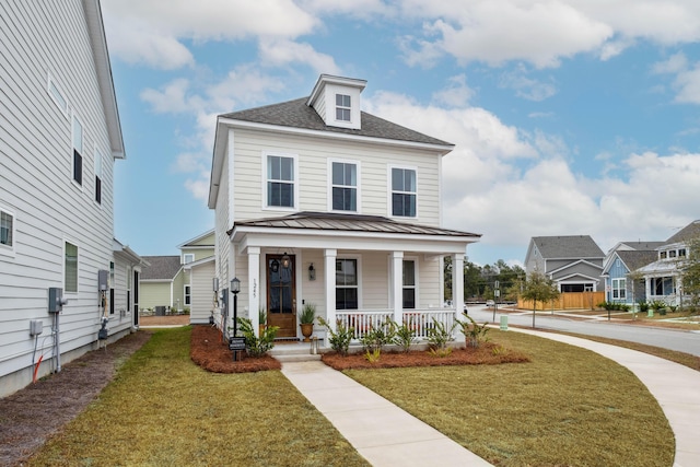 view of front facade featuring covered porch and a front yard