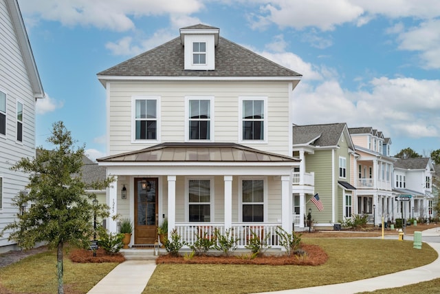 view of front of home with covered porch and a front yard