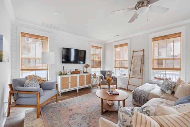 living room featuring ceiling fan, ornamental molding, and hardwood / wood-style floors