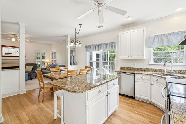 174 Revetment Ln, Mount Pleasant, SC 29464 - kitchen featuring stainless steel appliances, a ceiling fan, a sink, a center island, and light stone countertops