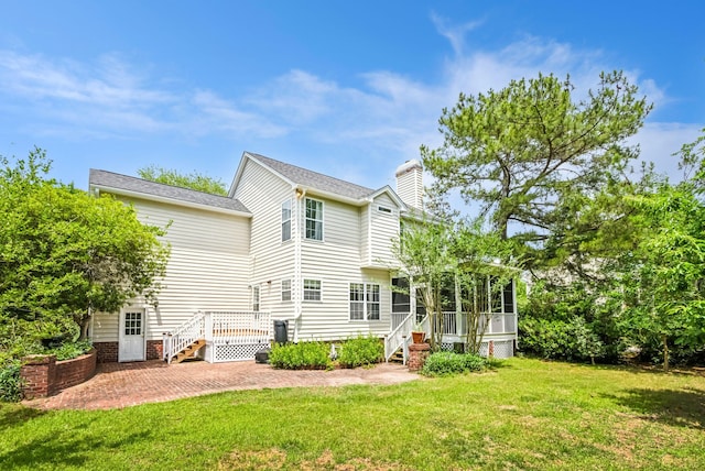174 Revetment Ln, Mount Pleasant, SC 29464 - rear view of property featuring a patio, a yard, a chimney, a sunroom, and a deck