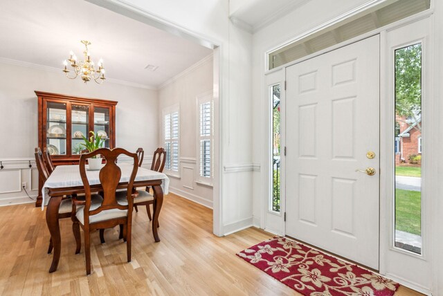 174 Revetment Ln, Mount Pleasant, SC 29464 - foyer entrance with a chandelier, crown molding, a decorative wall, and light wood-style floors