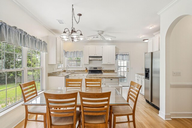 174 Revetment Ln, Mount Pleasant, SC 29464 - kitchen with stainless steel appliances, under cabinet range hood, a sink, crown molding, and white cabinetry