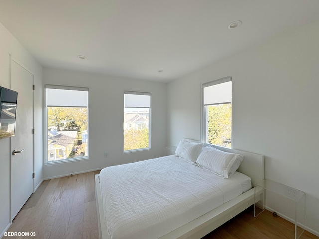 bedroom with light hardwood / wood-style floors