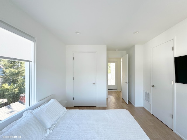 bedroom with light hardwood / wood-style flooring