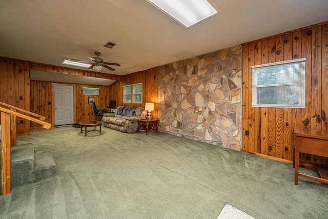 2567 Mona Ave, Charleston, SC 29414 - living room featuring wooden walls, carpet flooring, a textured ceiling, a ceiling fan, and stairs